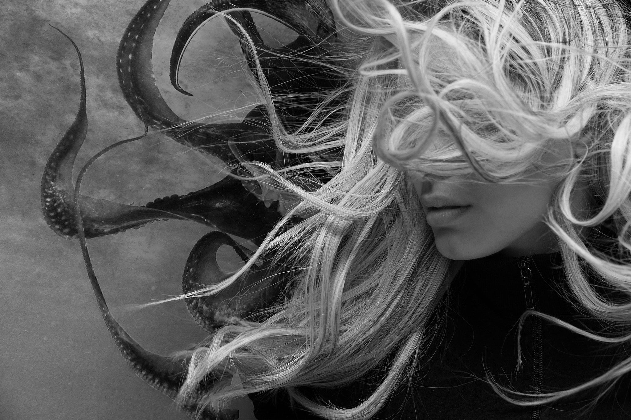 Monochrome fantasy portrait blending a woman's hair with octopus tentacles, creating a surreal, textured contrast of human and marine forms.