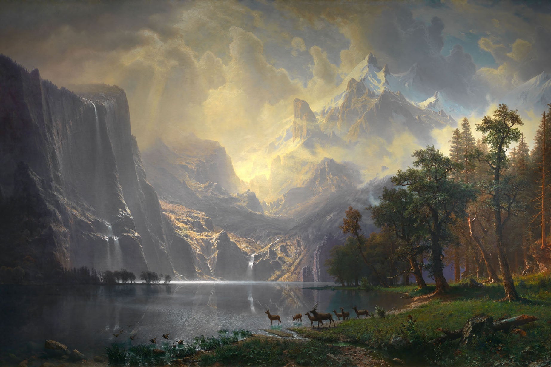 19th-century landscape painting by Albert Bierstadt featuring the Sierra Nevada Mountains with a golden sunrise, a cascading waterfall, and a reflective lake, showcasing the serene beauty and grandeur of the American West with dramatic and tranquil tones.