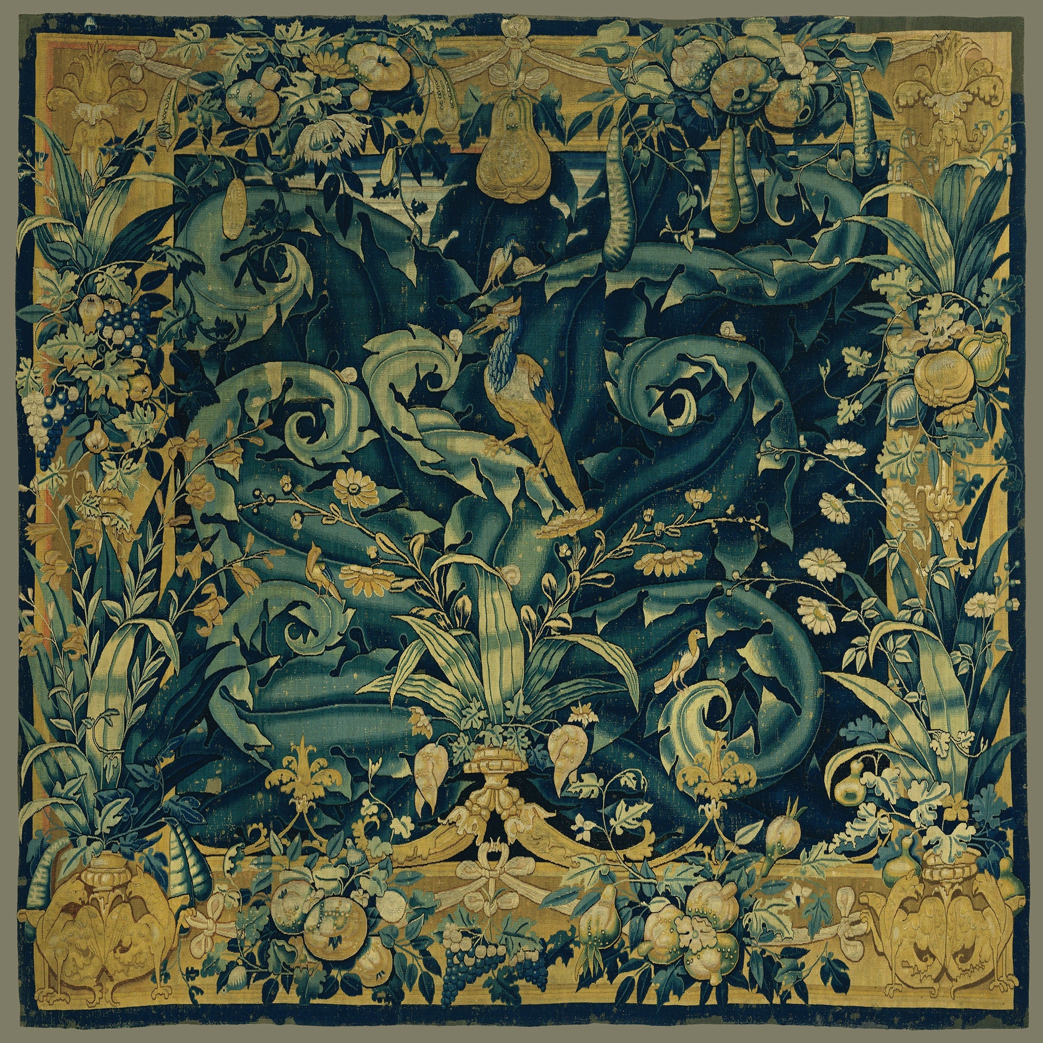 Vintage European tapestry featuring an intricate floral pattern in navy and gold, with ornamental acanthus and arabesque designs, showcasing traditional textile art and craftsmanship.