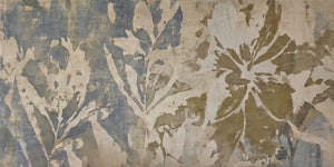 Wide-format abstract botanical art print featuring layered tropical and broad-leaf foliage silhouettes in a weathered fresco style, transitioning from cool slate blue-grey on the left to warm olive and khaki on the right, with creamy white negative-space leaf forms against a distressed, aged plaster-like textured background.