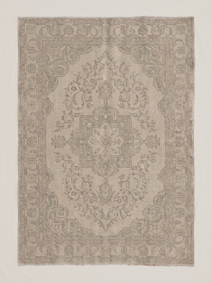Fine art print of a heavily faded and aged Persian or Turkish-style area rug featuring a central floral medallion, arabesque scrollwork, botanical detailing, and a repeating vine border, rendered in soft taupes, warm grays, and pale creams with a ghostly, ethereal quality.